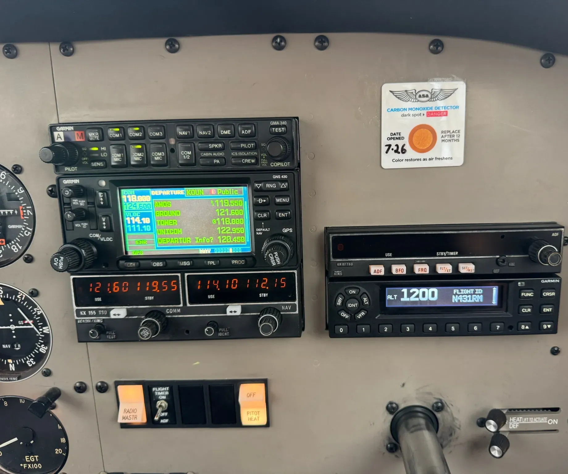 Center avionics stack with the Garmin GMA 340 audio panel, the Garmin GNS 430W GPS navigator and com, a King KX 155 nav and com radio, a King KR 87 ADF and the Garmin GTX 345 transponder.