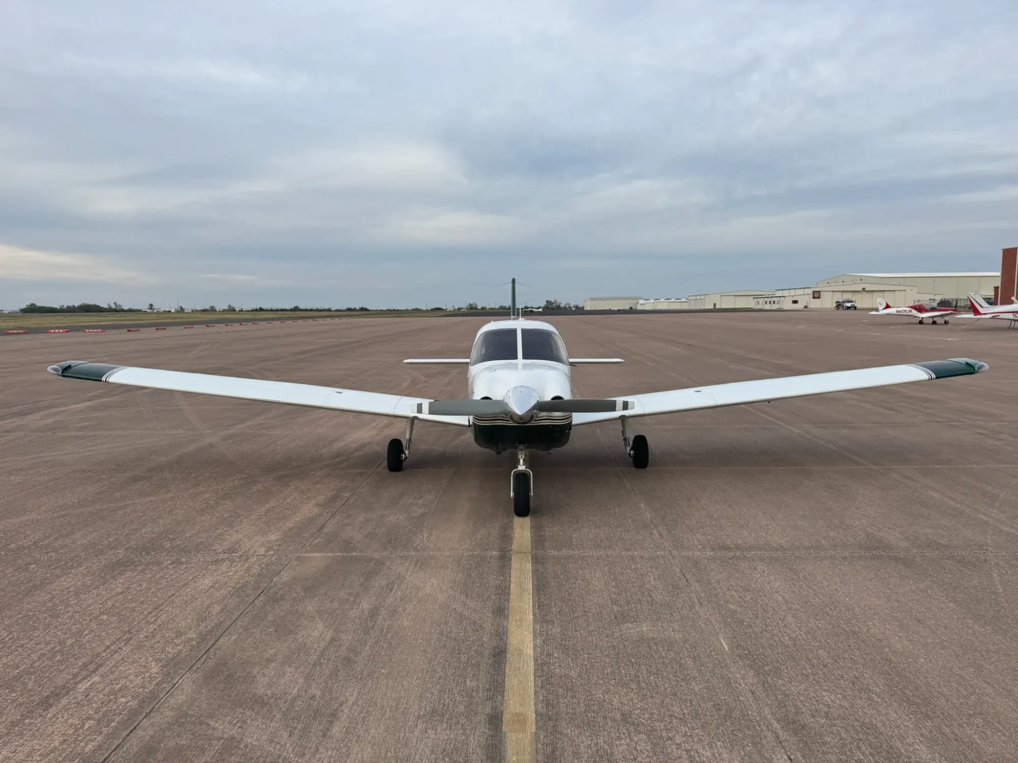 N431RM seen head-on, showing the full wingspan with green wingtips, the propeller and the nose gear.